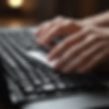 A close-up of a hand typing a follow-up email